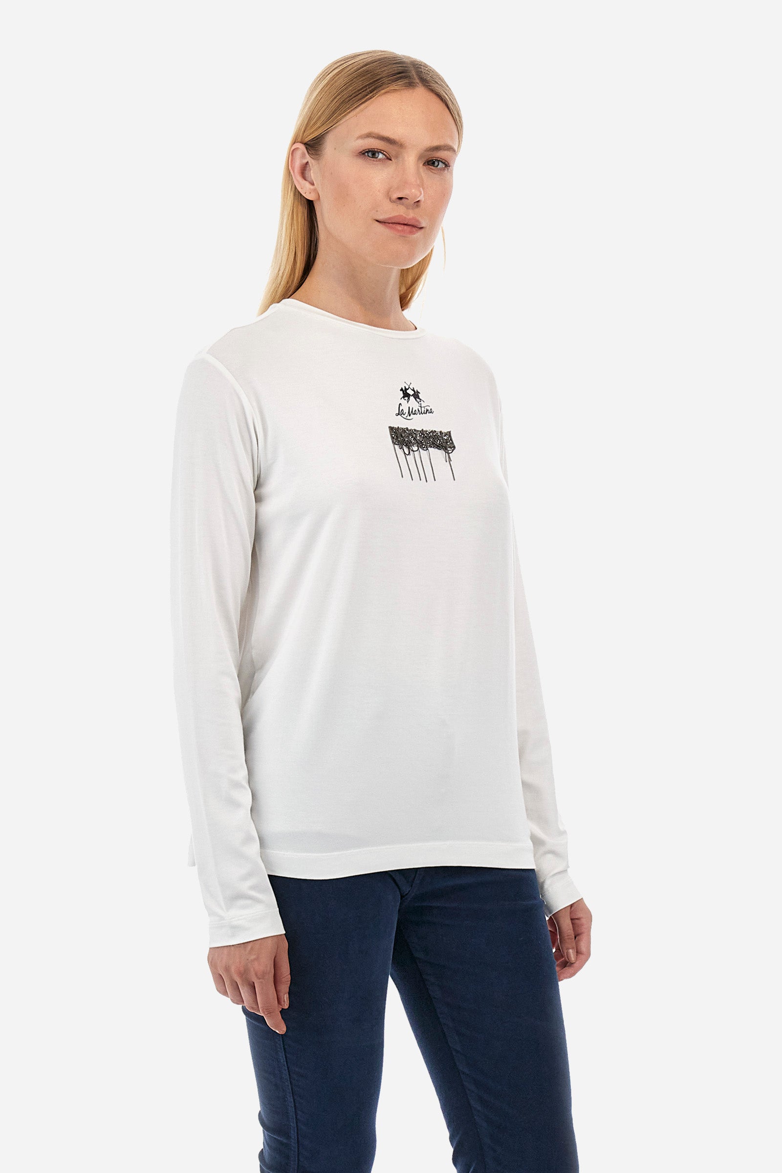 This long-sleeved women's T-shirt is made of stretch viscose for optimal comfort. The regular fit is perfect for any occasion. It features a basic solid colour suitable for any outfit. The crew-neck is enriched with a logo and a jewel detail for a touch of elegance. A versatile and quality garment for every woman's wardrobe. The model is 174 cm tall and wears a size 2. - Off White