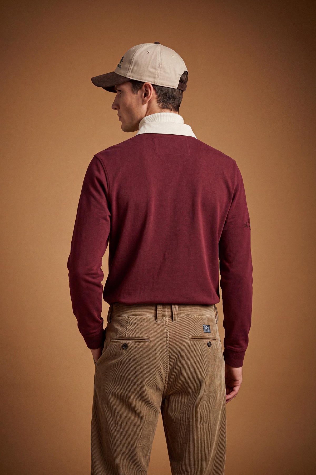 Men’s long-sleeve polo in heavy pure cotton jersey with textured fabric, hidden placket, ribbed cuffs, and heritage British polo graphic for a classic, clean fit. - Red Dahlia