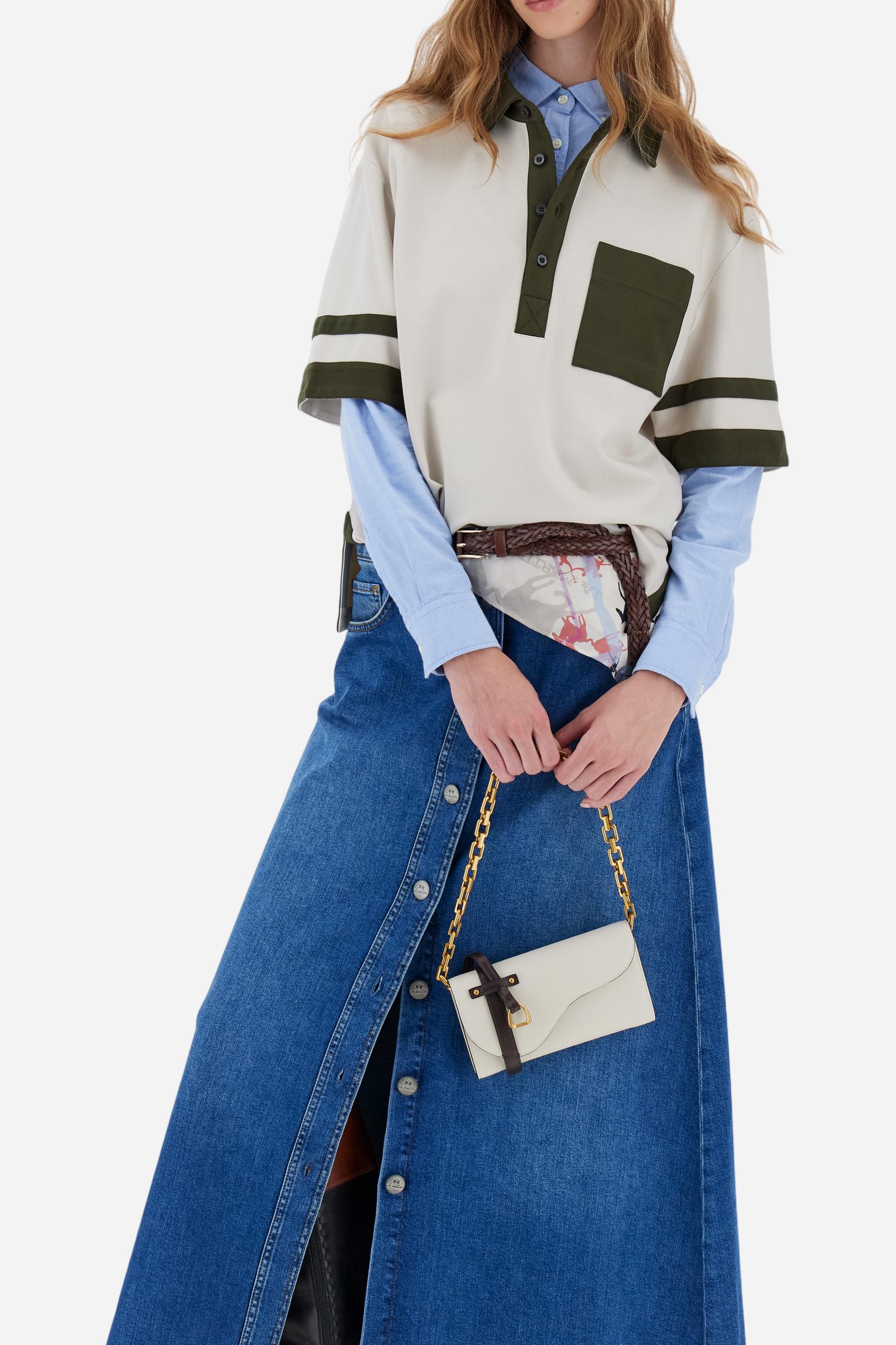 Women's long skirt in stretch cotton denim. 5-pocket model with front opening fastened by custom tack buttons.The logo features on the back of the eco-leather waistband applied to the right of the waist. The flared fit creates a feminine, fluid look. The model is wearing a size 2 - Medium Indigo Denim