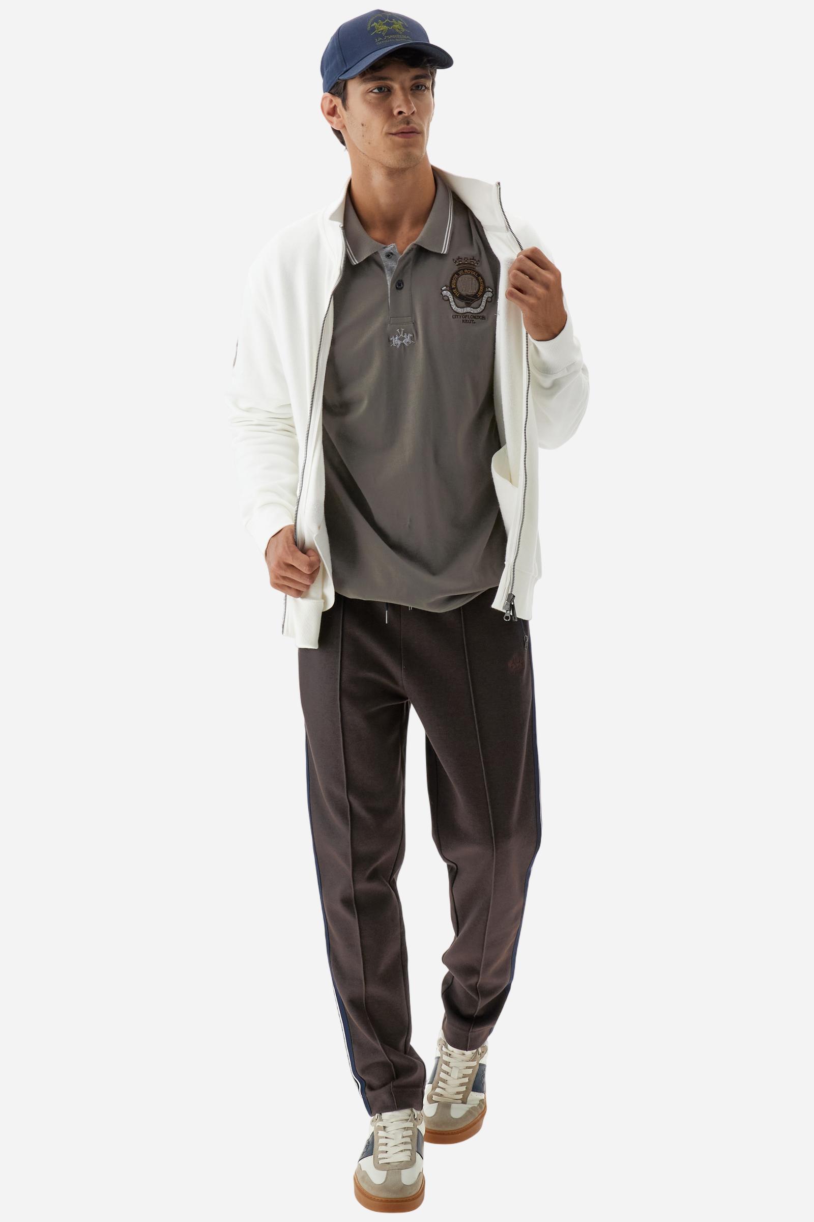 Long-sleeve polo shirt in stretch cotton jersey, soft and breathable. Ribbed collar with contrast striped edge and inner tartan ribbon. A colorful embroidered crest enriches the chest, complemented by a tonal embroidered logo under the placket with two personalized buttons. Regular fit for a versatile, timeless look. Model wears size L. - Falcon