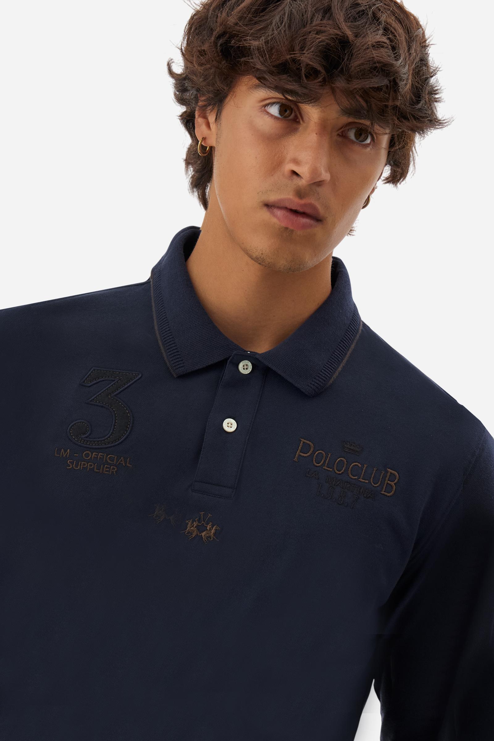 Men’s long-sleeve polo in stretch piqué, solid color. Ribbed collar and cuffs with striped details for a refined touch. Contrast fabric insert under the collar. Chest patch with number 3 and embroidered lettering celebrating the Polo Club. Small brand logo embroidered in contrast under the front placket. Regular fit. Model wears size L. - Navy