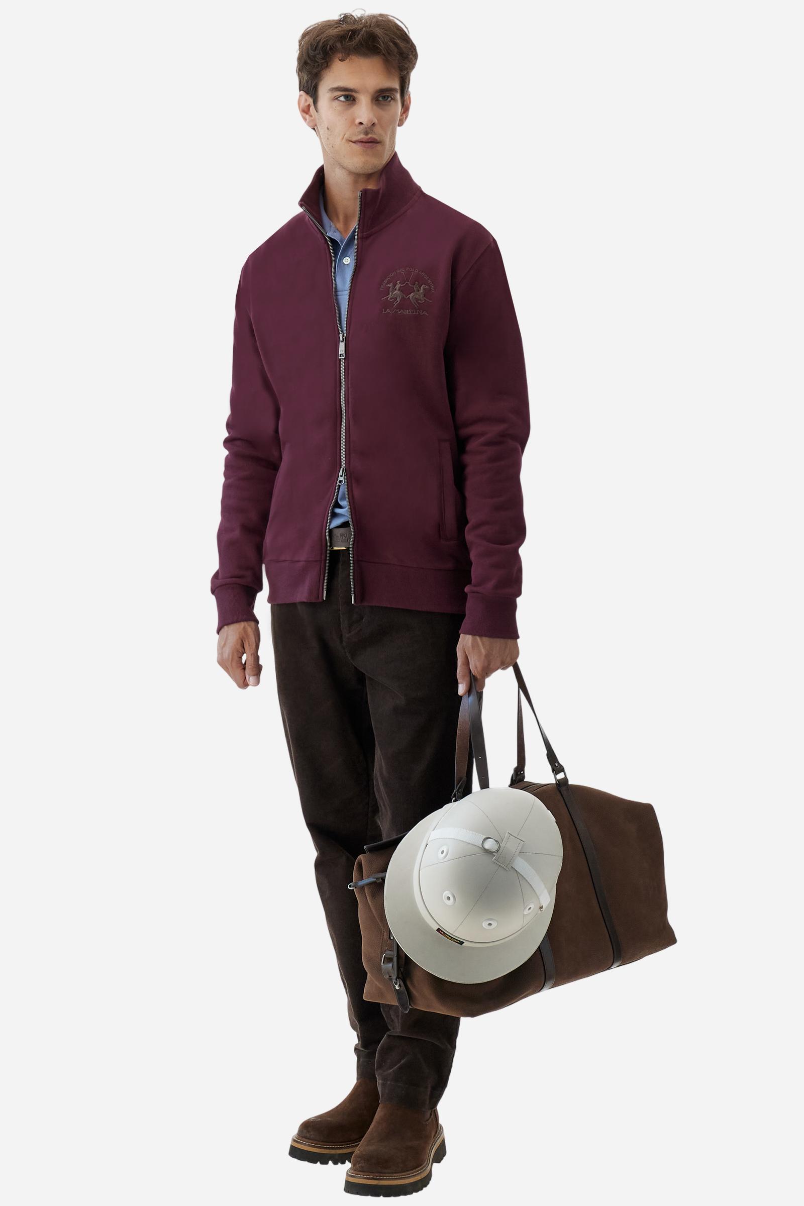 Men's long-sleeved solid colour sweatshirt. It is made of comfortable 100% cotton fleece with a soft-brushed feel. Model with high ribbed neck and front zip opening. Solid colour ribbed cuffs and waistband. The large contrasting brand team logo is embroidered on the chest. A contrasting colour fabric number patch is applied to the right sleeve. The model has a regular fit that offers a comfortable, relaxed silhouette. The model is wearing a size L. - Port Royale