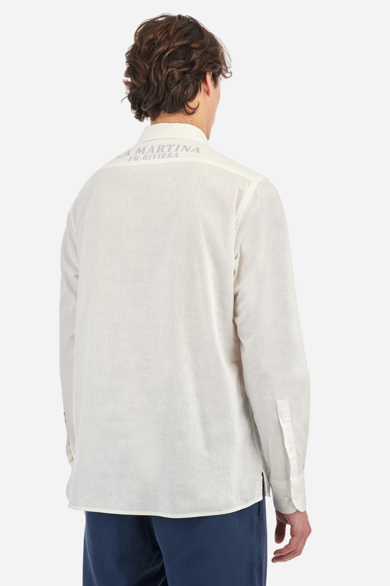 Men's plain long-sleeved shirt, made from luxurious cotton and linen canvas. The spread collar and the opening, which reaches the waist, are closed with 4 buttons. The left bicep is embellished with embroidered graphics depicting lettering, crests and numbers, created using contrasting thread. The logo is embroidered in contrasting thread on the left side of the chest. The regular fit offers a refined and comfortable look. The model is wearing a size L. - Optic White