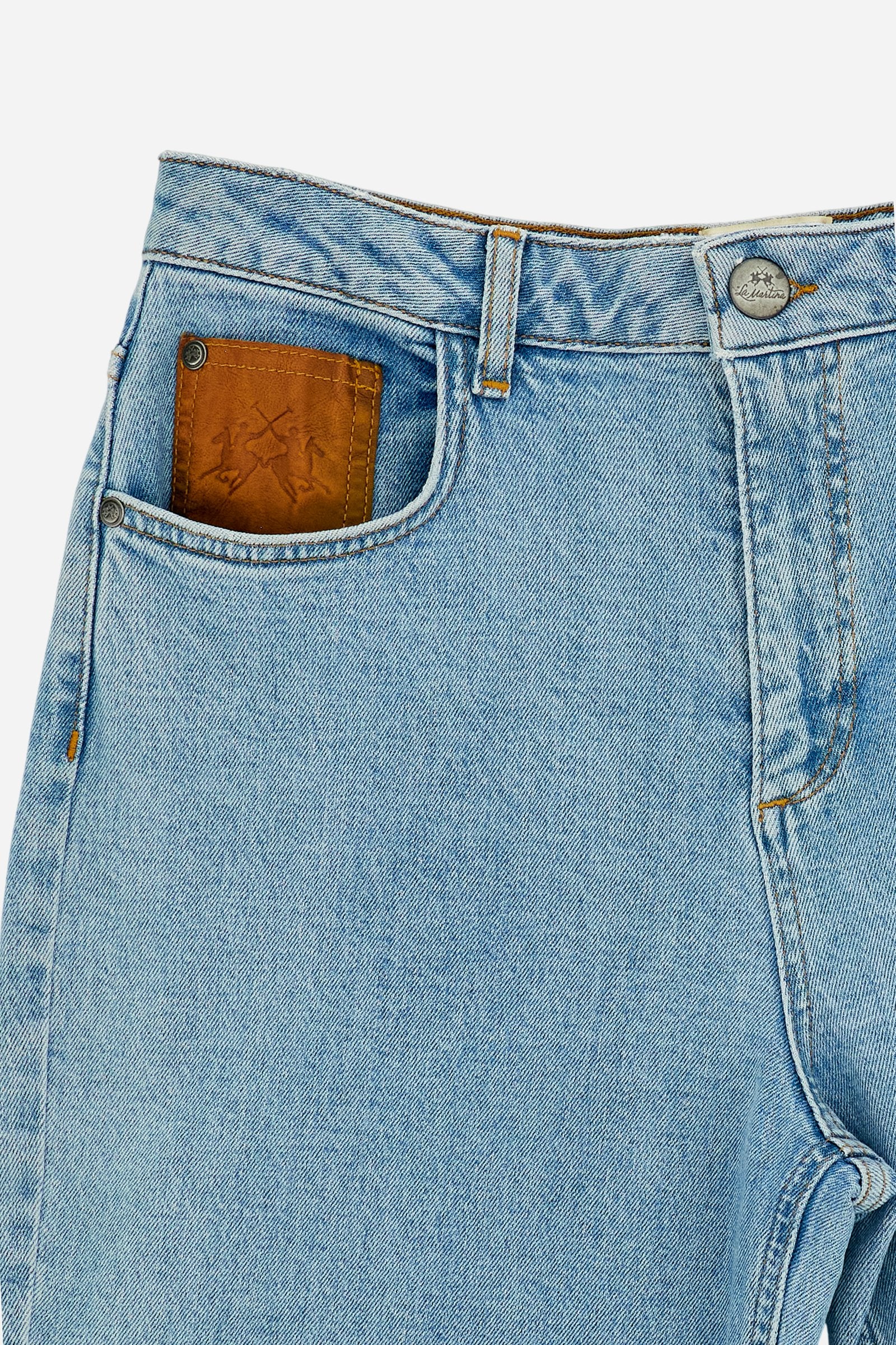Women’s denim jeans in light-medium wash with a five-pocket style, wide leg, and raw-cut hem. Features logo details on pockets and leather patch. - Medium Indigo Denim