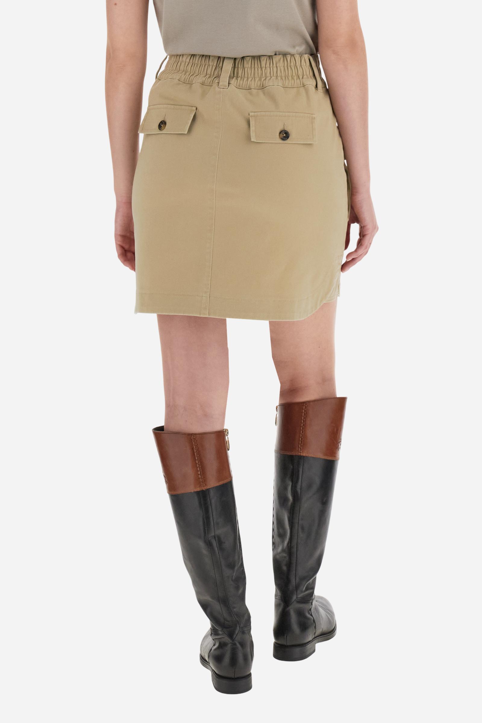 Women’s mini skirt in solid-colour stretch cotton twill. Front closure with zip and internal hook, elasticated back waistband for added comfort. Applied front pockets with personalised horn-effect buttons and decorative flaps on the back. Logo on faux leather label applied to the front pocket. Flared, fluid silhouette for a feminine and comfortable look. The model wears size 2. - Travertine