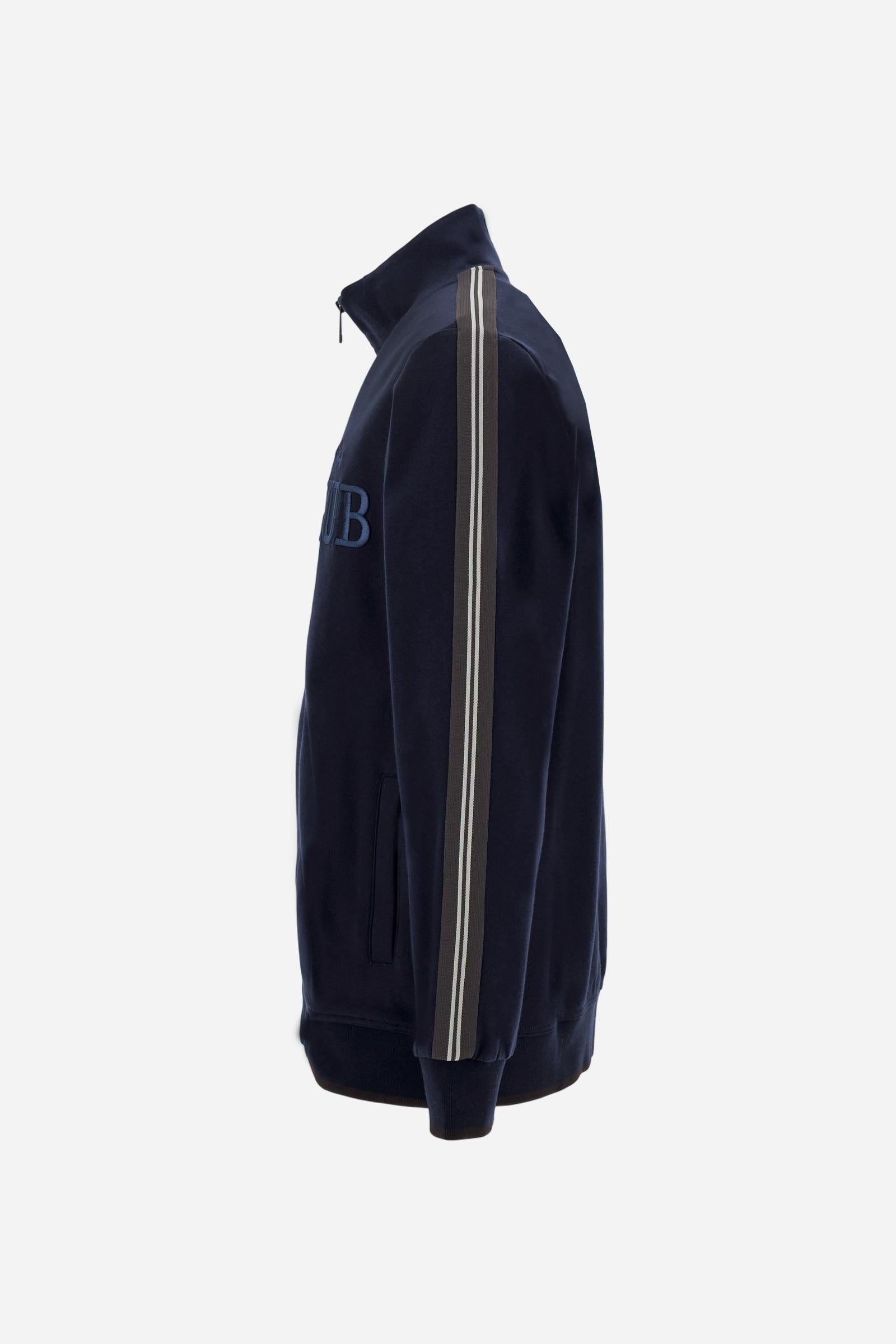 Men's long-sleeved, full-zip sweatshirt. Made of soft solid colour cotton fleece. The neck and cuffs and waistband are in solid colour ribbed knit with contrasting edging. Front zip opening and Polo club guarantee label applied to the edge inside the collar. The front lettering is a large tone-on-tone raised embroidery. A narrow two-tone striped band is applied to the shoulders and sleeves. Regular fit. The model is wearing a size L. - Navy