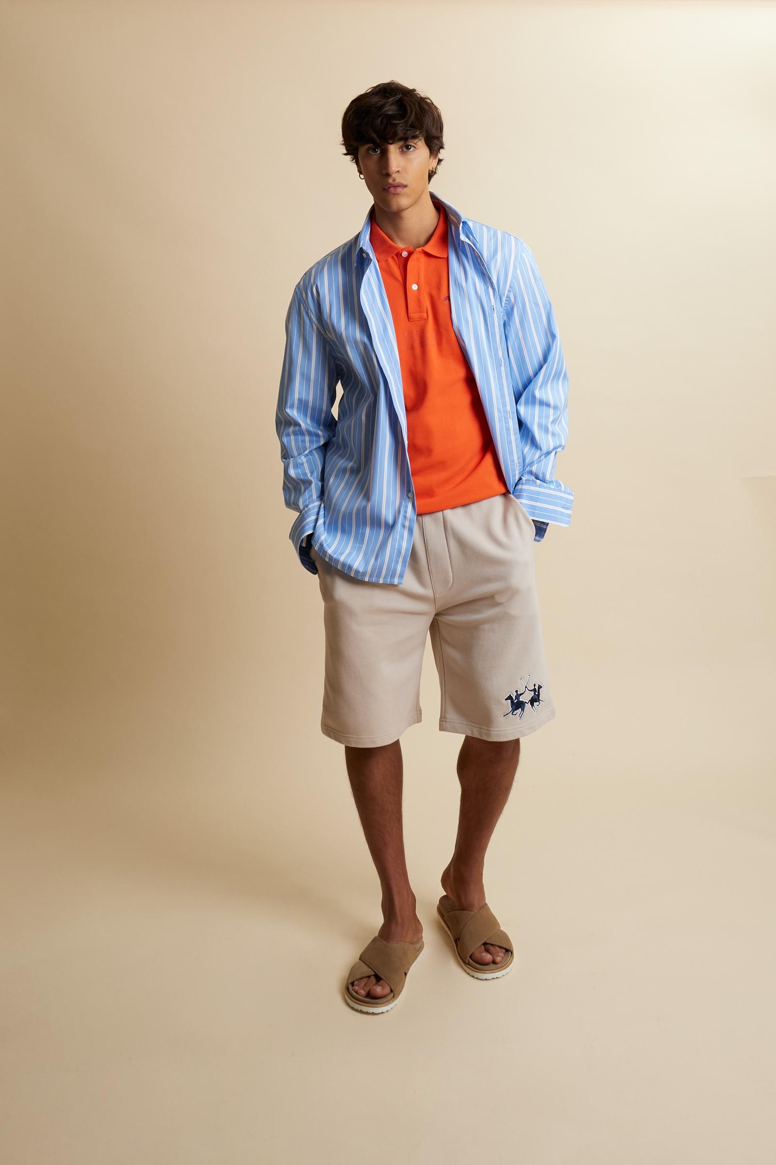 Men’s short-sleeve polo in solid 100% cotton piqué. Regular fit with matching ribbed details. Part of the “Nations” collection celebrating countries of the World Polo Tour through embroidered and printed graphics. Small contrast logo on the chest. The model wears size L. - Flame                                                                                                                                                                                                                                         