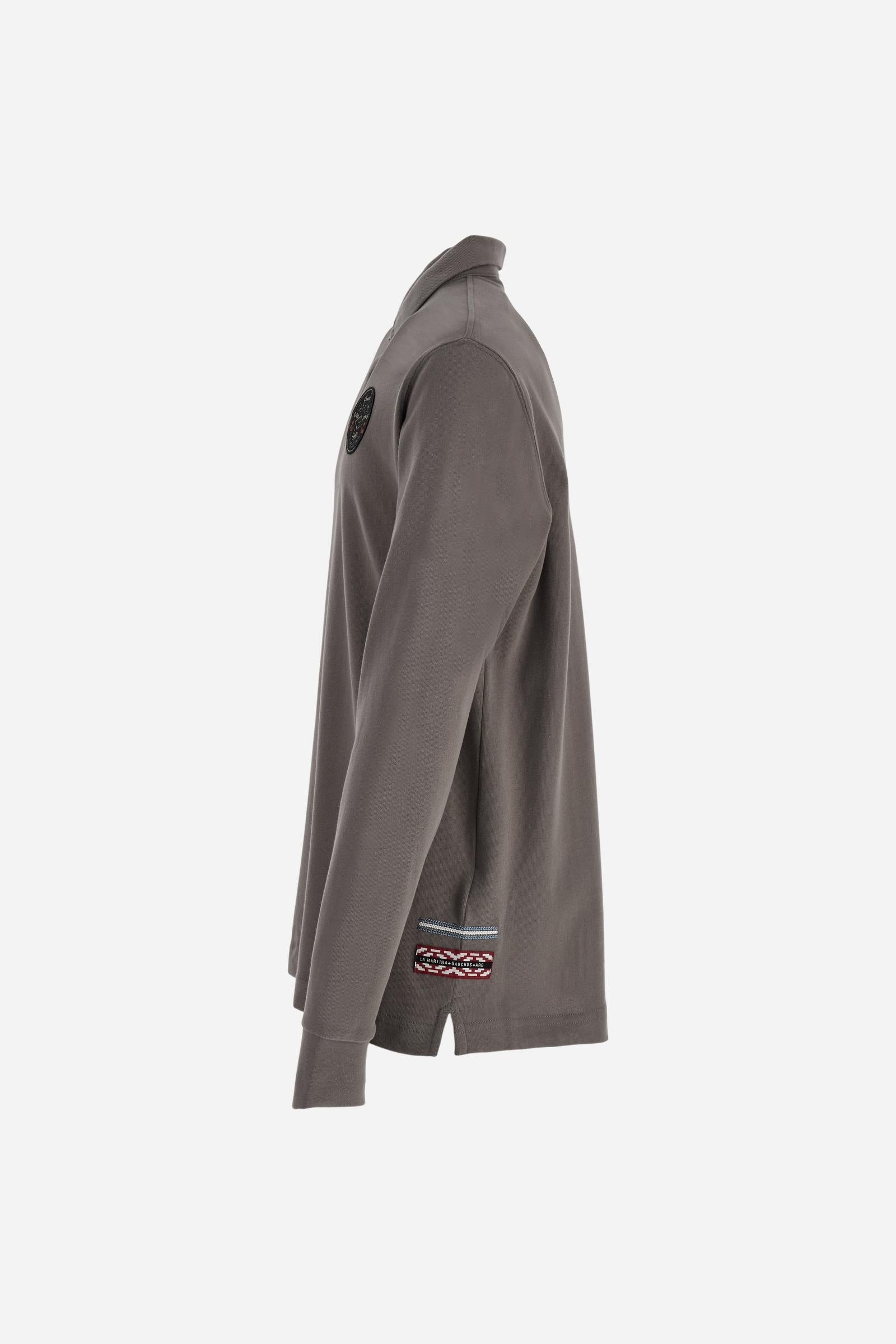 Long-sleeve polo shirt crafted from 100% high-quality cotton jersey. The velvety fabric offers a warm, cozy feel, perfect for cooler seasons. Ribbed collar and cuffs in matching tone, with a three-button personalized placket. A small multicolor embroidered logo sits below the opening, while tonal patches in different shapes and textures, inspired by Argentine culture and Gaucho tradition, decorate the chest and back. Classic regular fit. Model wears size L. - Falcon