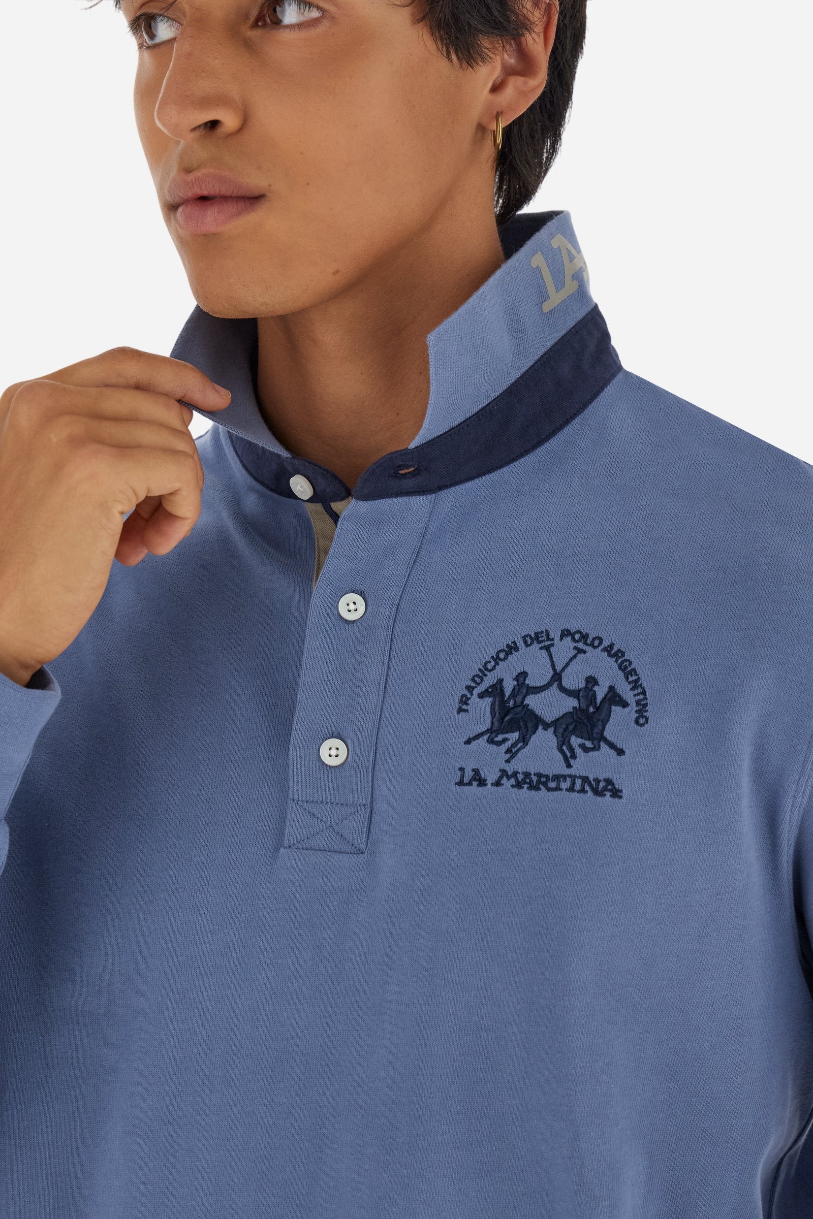 Men’s long-sleeve polo in premium soft-touch cotton jersey for a luxurious feel on the skin. Contrast gabardine details on the collar. Upper collar in tone-on-tone ribbing with printed La Martina lettering undercollar. Three customized buttons, enhanced by a multicolor striped tape on the placket. Contrast embroidered team logo on the chest. Regular fit. Model wears size L. - Flint Stone