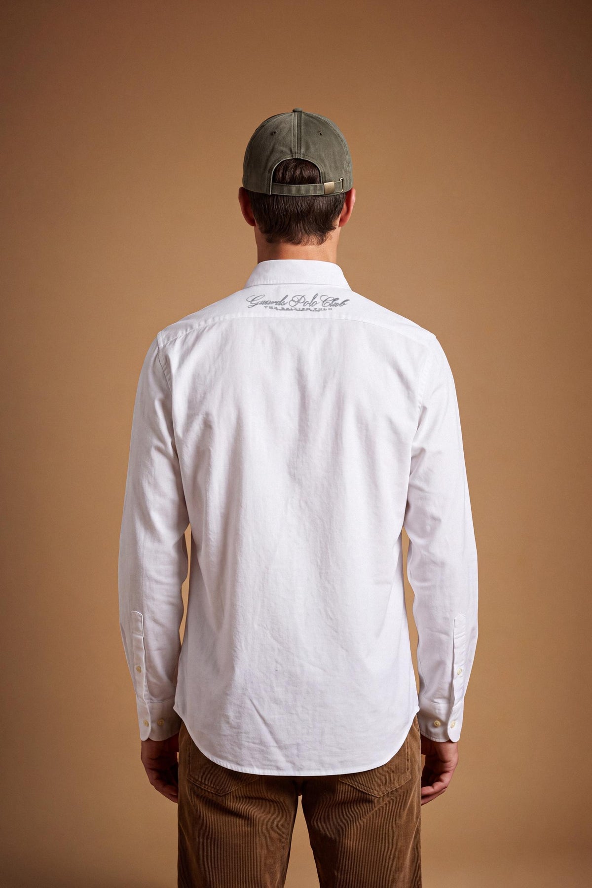 Men’s long-sleeve 100% cotton Oxford shirt with classic collar, button closure, embroidered details, red contrast stitching, and a comfortable regular fit with rounded hem. - Optic White