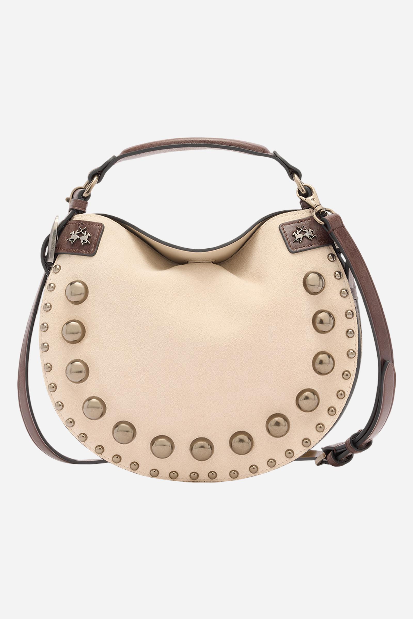 Medium-sized half-moon bag made of suede in a solid colour with side leather inserts and the brand’s signature metallic logo. Hidden magnetic closure, structured handle and contrasting leather shoulder strap. Front decorated with metallic studs of different sizes creating a refined play of light and volume. - SILK/DARK CHOCOLATE